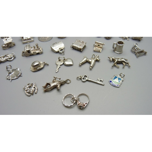 979 - Twenty-five silver and white metal charms, all stamped or test as silver, 72g