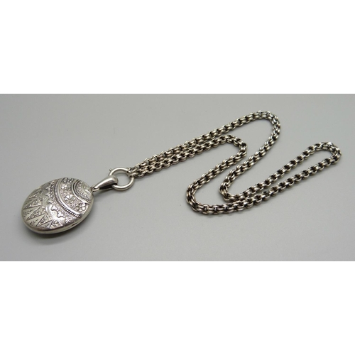 982 - A Victorian silver locket and chain, locket hallmarked Chester 1881, locket 27mm wide, chain require... 