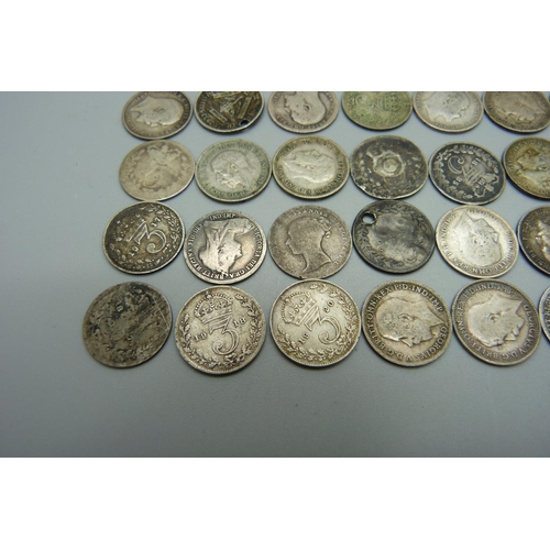 986 - A collection of mainly silver 3d coins including Victorian and a Victorian silver gilt four pence co... 