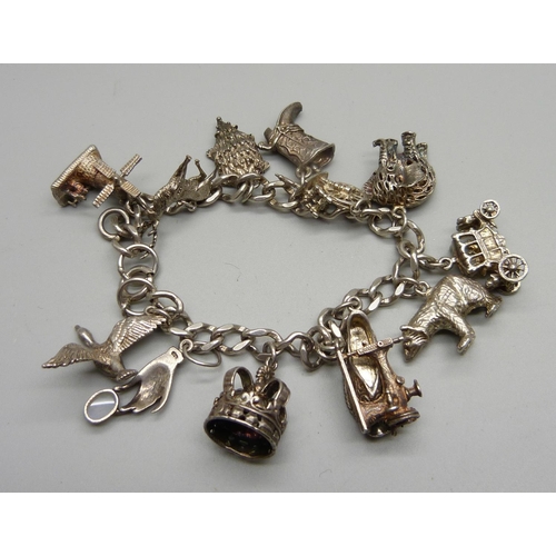 990 - A silver charm bracelet, one charm set with an opal, 61g