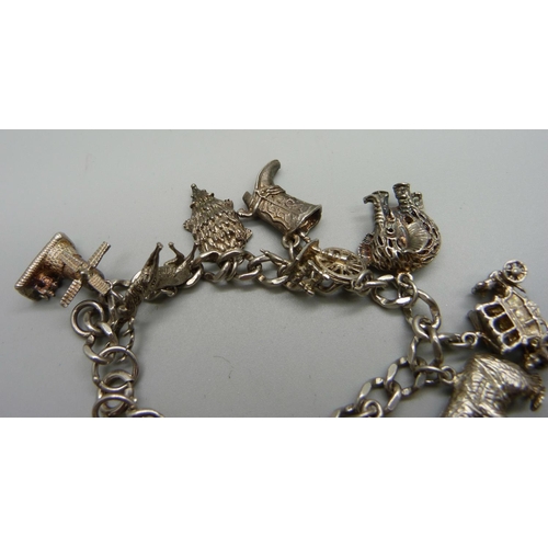 990 - A silver charm bracelet, one charm set with an opal, 61g