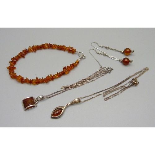 995 - Two silver and amber pendants and chains, a pair of silver and amber drop earrings and an amber brac... 