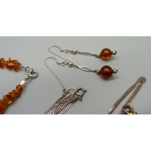 995 - Two silver and amber pendants and chains, a pair of silver and amber drop earrings and an amber brac... 