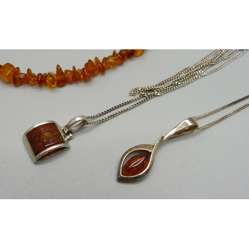 995 - Two silver and amber pendants and chains, a pair of silver and amber drop earrings and an amber brac... 