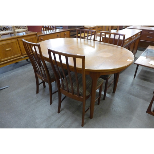 101A - A McIntosh teak extending dining table and four chairs