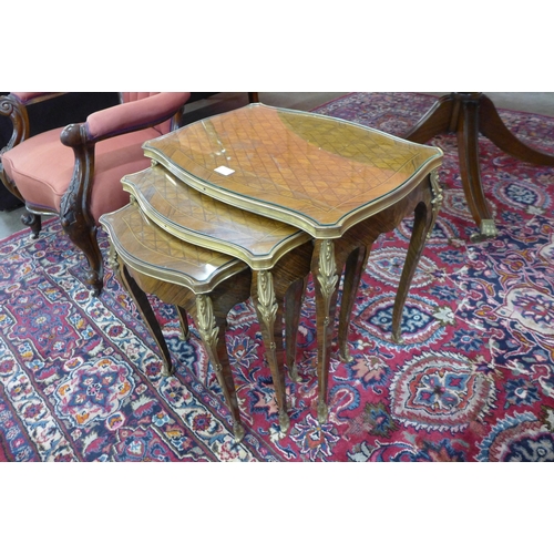 109 - A late 19th/early 20th Century French parquetry inlaid rosewood and gilt mounted nest of tables