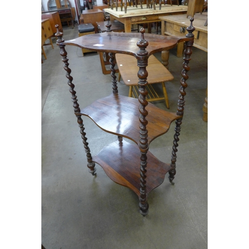 117 - A Victorian rosewood serpentine three tier whatnot