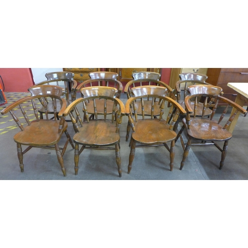 125 - A set of eight early 20th Century elm and beech smokers bow chairs