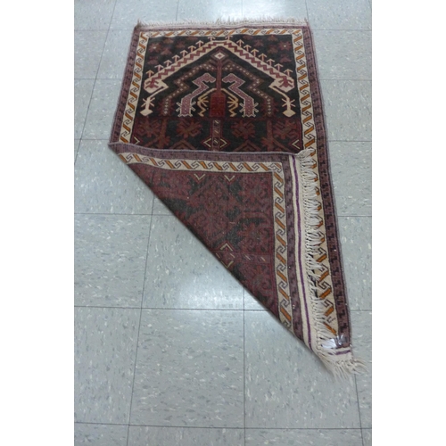 137 - A Persian Nomadic Belouch rug, 78 x 135cms