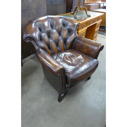 153 - A Wade Upholstery mahogany and chestnut brown leather upholstered armchair