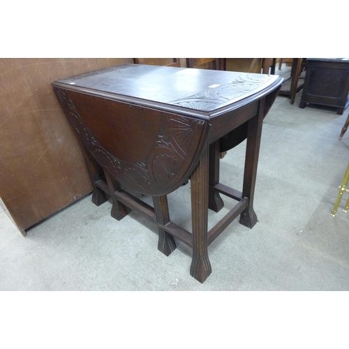 157 - An early 20th Century carved oak gateleg table