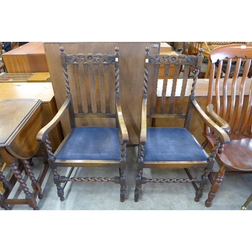 166 - A pair of early 20th Century oak barleytwist elbow chairs