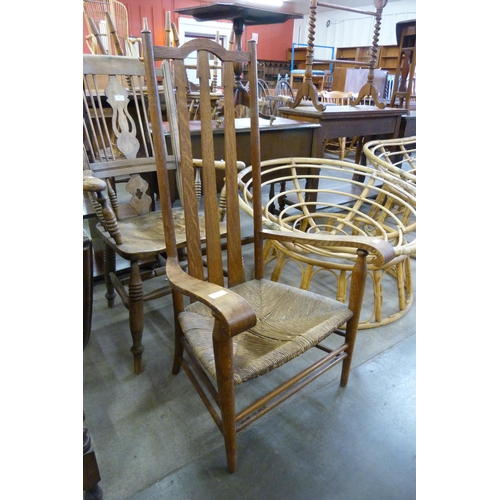 206 - An Arts and Crafts oak and rush seated fireside chair