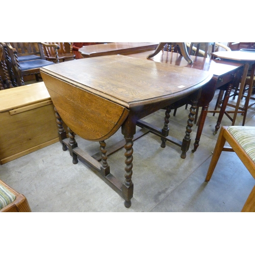 208 - An oak barleytwist gateleg table and four chairs