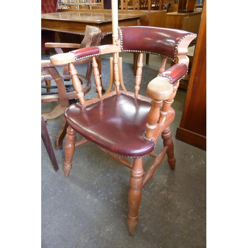 219 - A beech and red leather smokers bow chair