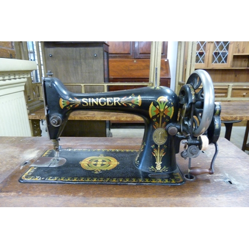 232 - A Singer oak and cast iron based treadle sewing machine