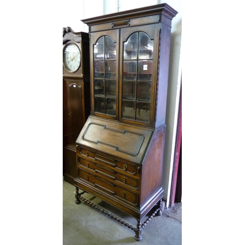 236 - A 17th Century style oak geometric moulded barleytwist bureau bookcase