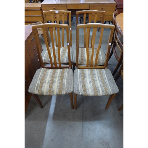 24 - A set of four teak dining chairs