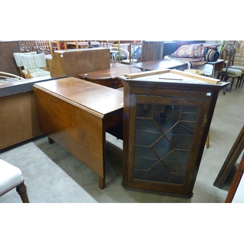 254 - A George III mahogany drop-leaf table and an oak splay front wall hanging corner cabinet