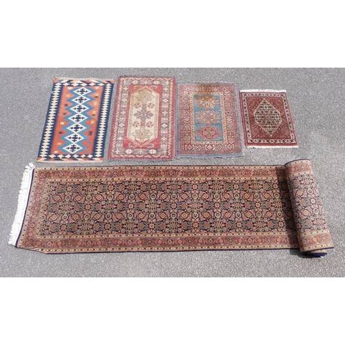 257 - A blue ground runner rug and three other small rugs