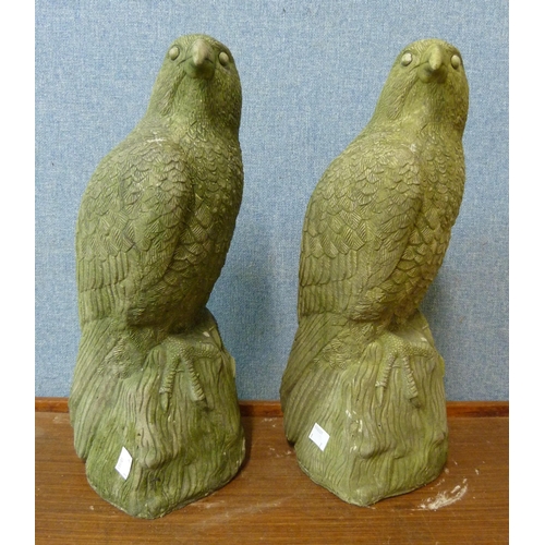 296 - A pair of concrete garden figures of birds of prey