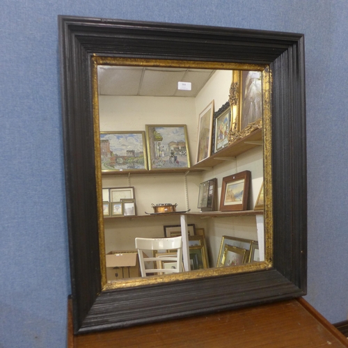 364 - An ebonised and parcel gilt framed mirror