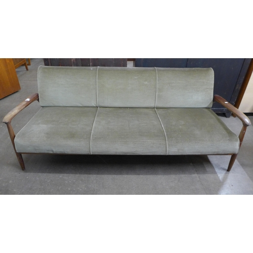 63 - A Guy Rodgers teak and green fabric upholstered settee/daybed. This lot is offered as a work of art,... 