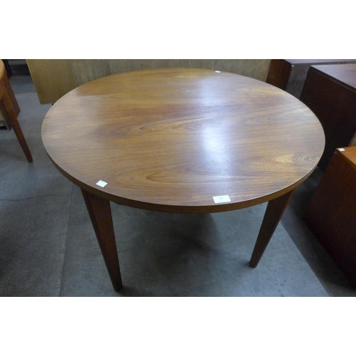 72 - A Uniflex teak circular extending dining table