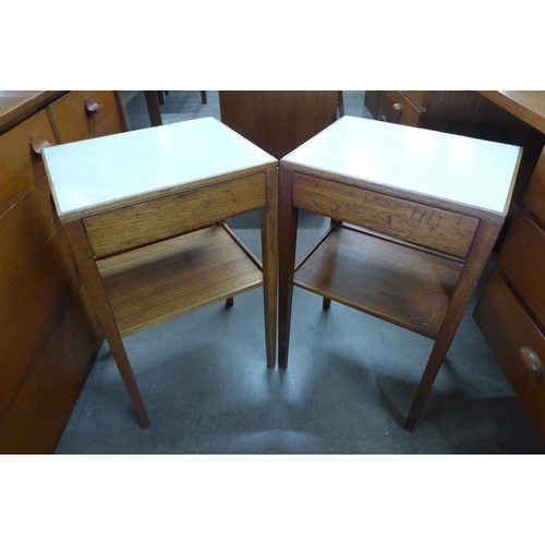 90 - A pair of teak and Formica topped single drawer side tables