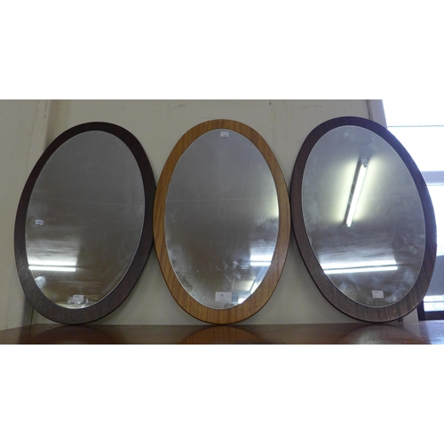95 - Three oval teak framed mirrors