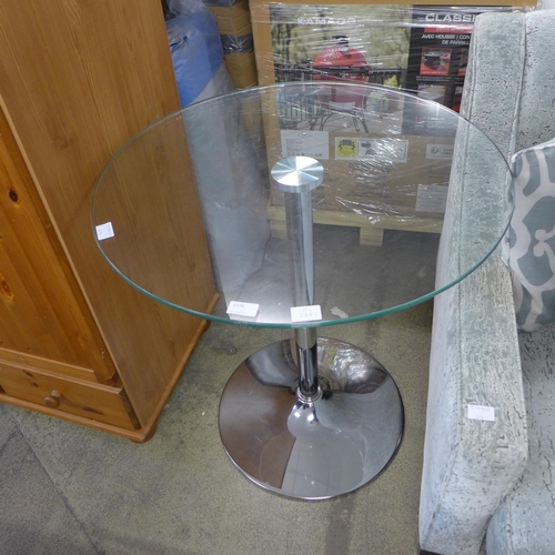 1570 - A small glass topped and chrome pedestal table