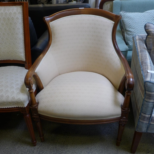 1610 - An oak and cream upholstered armchair