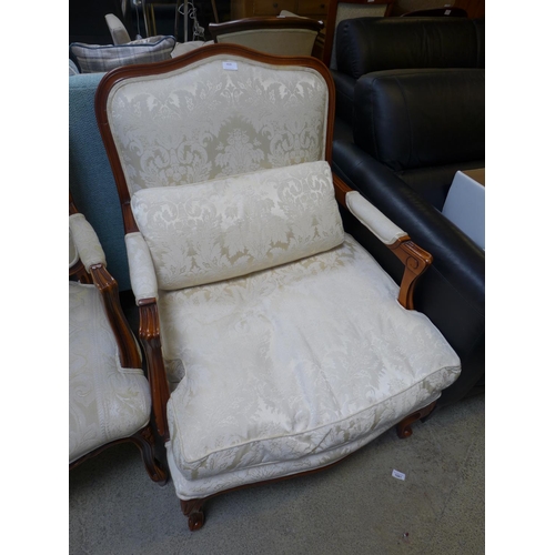 1626 - An oak and cream patterned upholstered armchair