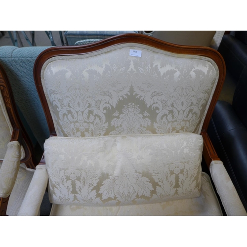 1626 - An oak and cream patterned upholstered armchair