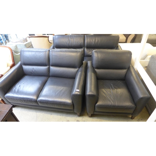 1628 - A black leather three seater, two seater, armchair and footstool