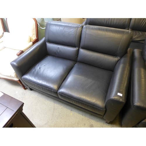 1628 - A black leather three seater, two seater, armchair and footstool