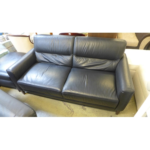 1628 - A black leather three seater, two seater, armchair and footstool