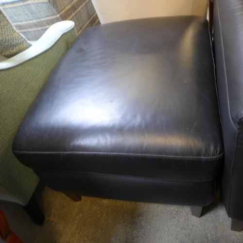 1628 - A black leather three seater, two seater, armchair and footstool