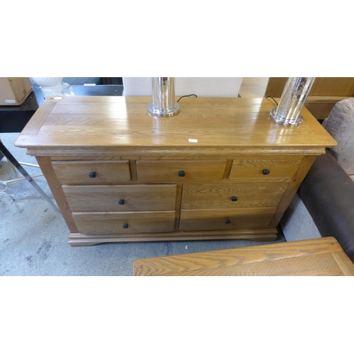 1606 - A natural oak 3 over 4 chest of drawers