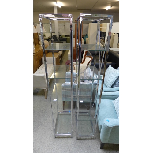 1616 - A pair of chrome shelving units, with glass shelves