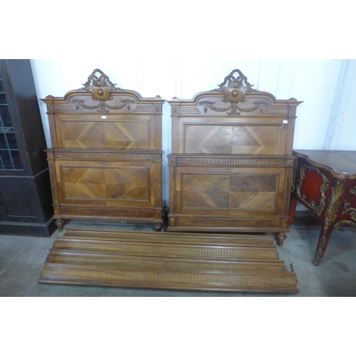 598 - A pair of 19th Century French carved walnut single beds