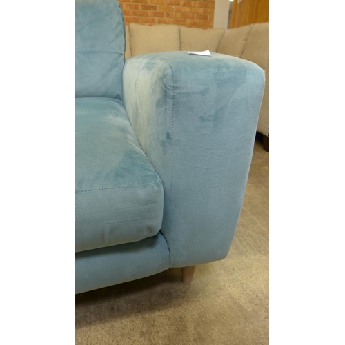 1318 - An aquamarine pinch back velvet three seater sofa