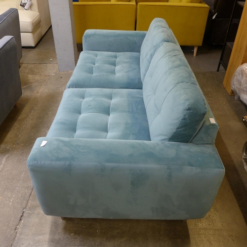 1318 - An aquamarine pinch back velvet three seater sofa