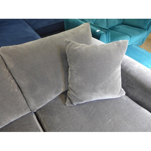 1340 - A fossil grey velvet three seater sofa and ottoman footstool