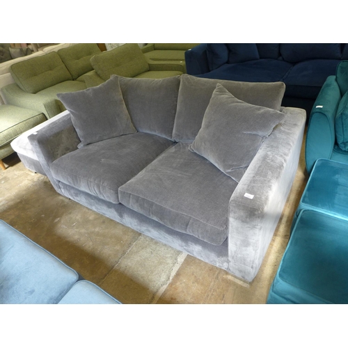 1340 - A fossil grey velvet three seater sofa and ottoman footstool