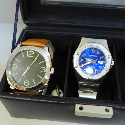 630 - Three gentleman's wristwatches in display case