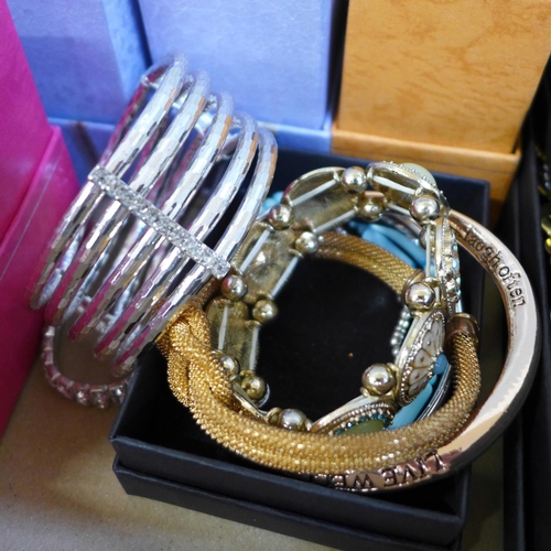 676 - A collection of costume bangles and bracelets, new in boxes