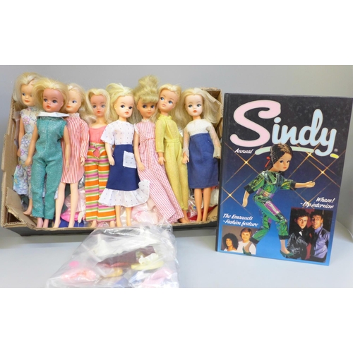 691 - Vintage Sindy dolls with clothes, shoes, etc., and a 1985 annual