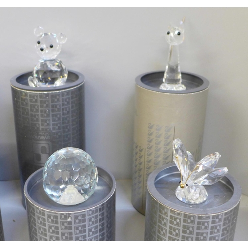 697 - Ten Swarovski glass animals including a butterfly, polar bear, flower, penguin, mouse etc, boxed