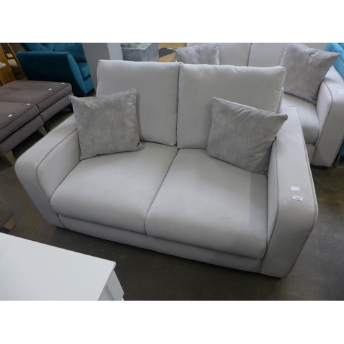 1451 - A frost white with grey piping corduroy upholstered two seater sofa